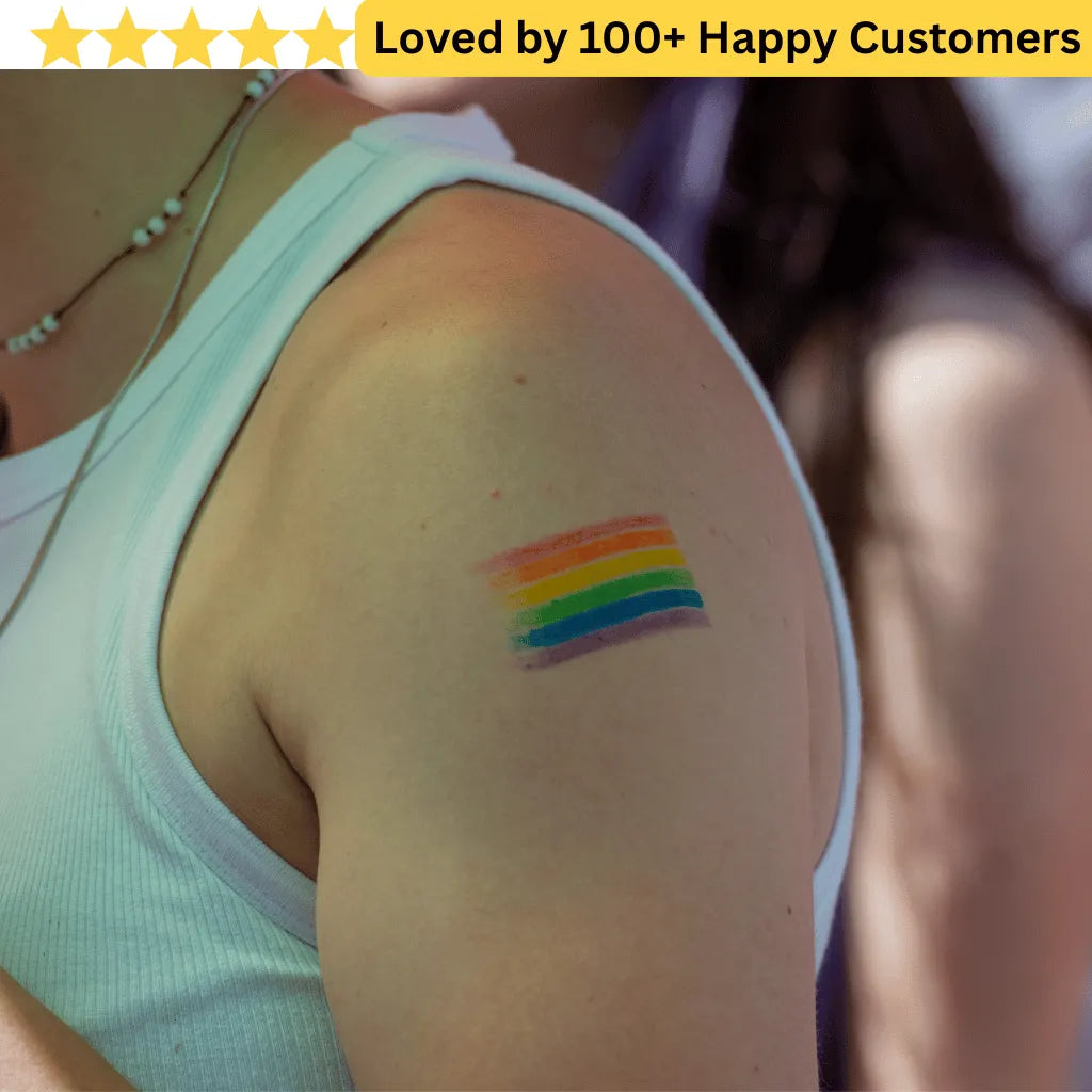 Person wearing a white tank top with a rainbow tattoo on their arm, surrounded by text 'Loved by 100+ Happy Customers'.