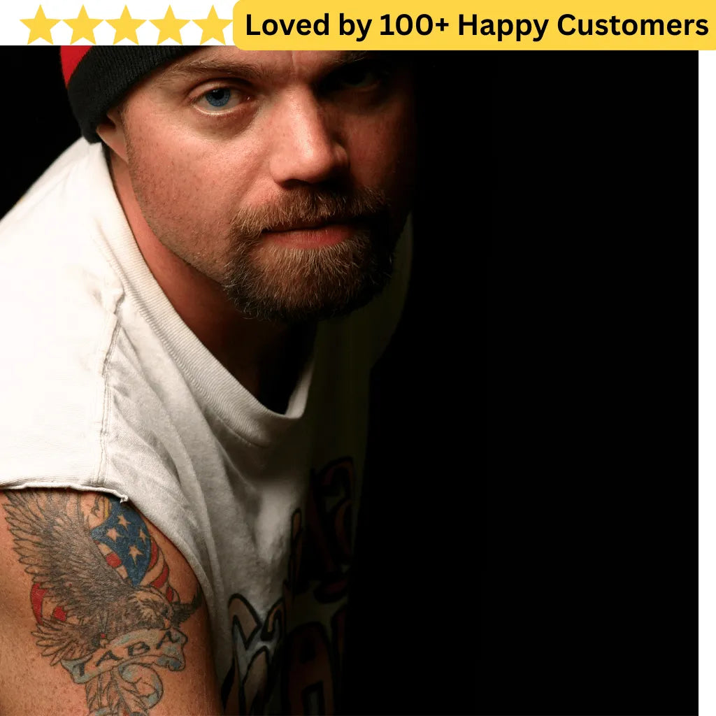 Man with tattoos wearing a white shirt against a dark background, with text 'Loved by 100+ Happy Customers' at the top.