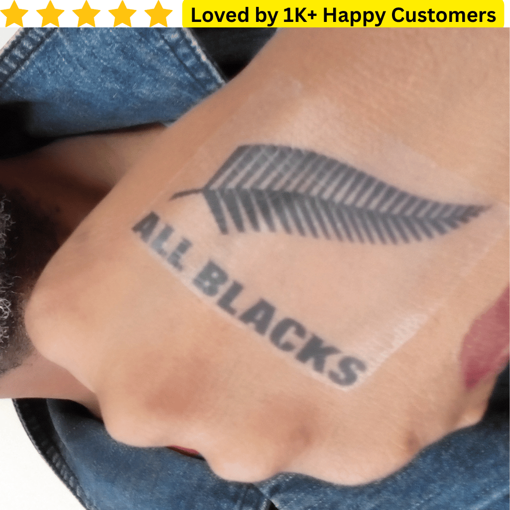 Tattoo of 'ALL BLACKS' on a person's arm with a star rating and text above. Temporary Tattoo Printing – Fast, Affordable & Local