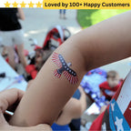 American flag tattoo on a person's arm with a blurred background of people and flags.
