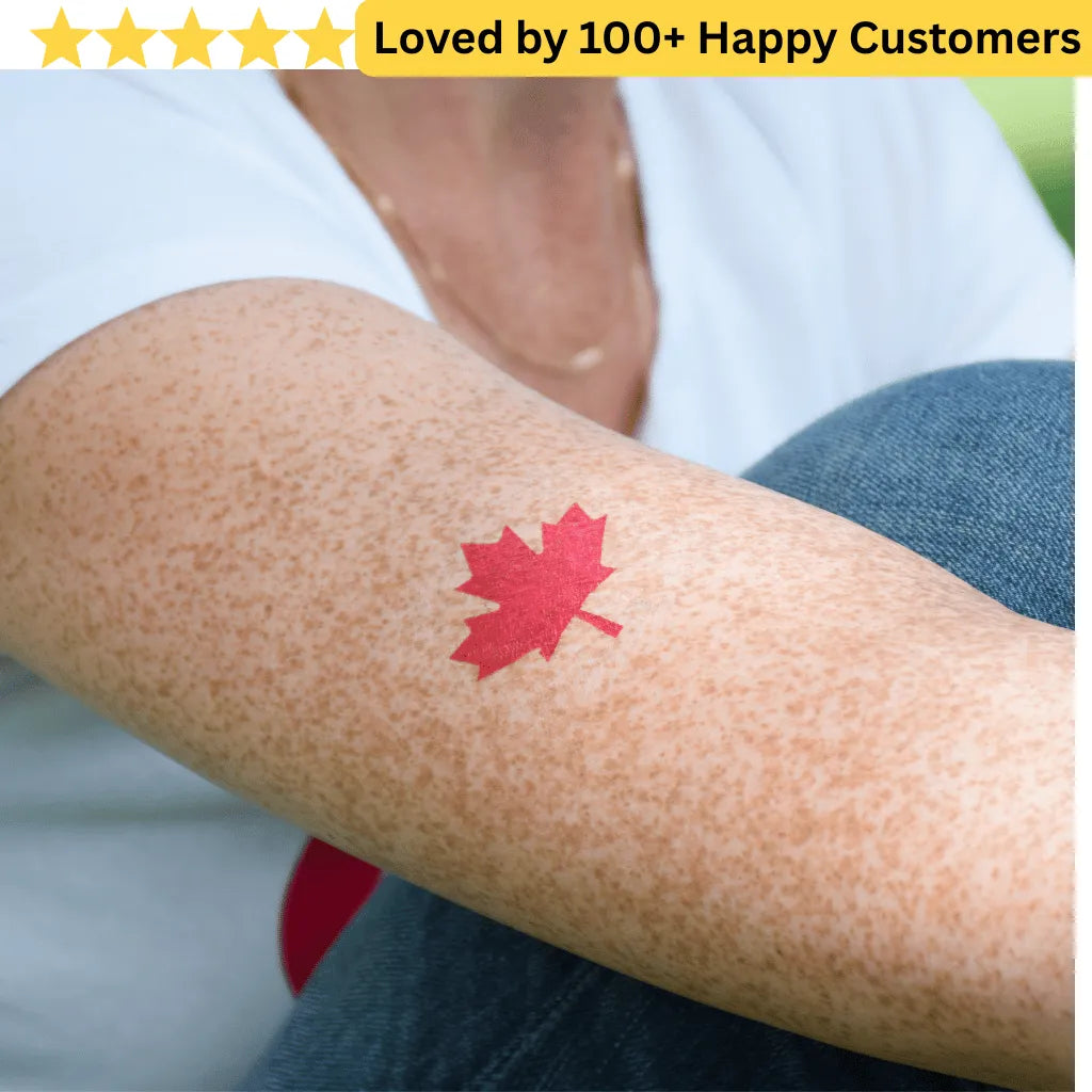 Red maple leaf tattoo on a person's arm with a blurred background. Springboks Tattoo - Print Sports Team Temporary Tattoos