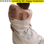 Woman with tattoos on her back wearing a beige dress, with text 'Loved by 1K+ Happy Customers' at the top. TeMaRo tattoos near me 