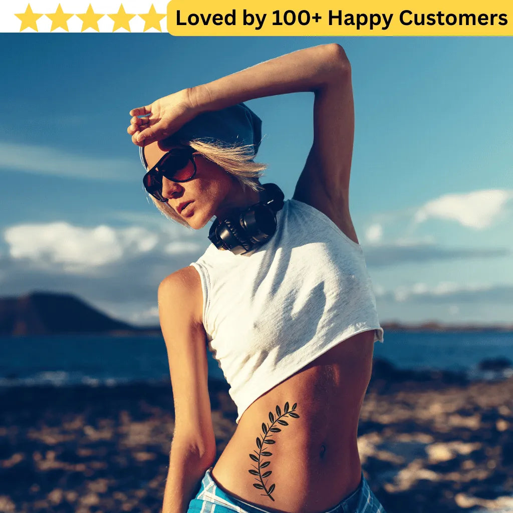Woman with a leaf tattoo outdoors, wearing sunglasses and a white sleeveless top. Floral Tattoo Designs