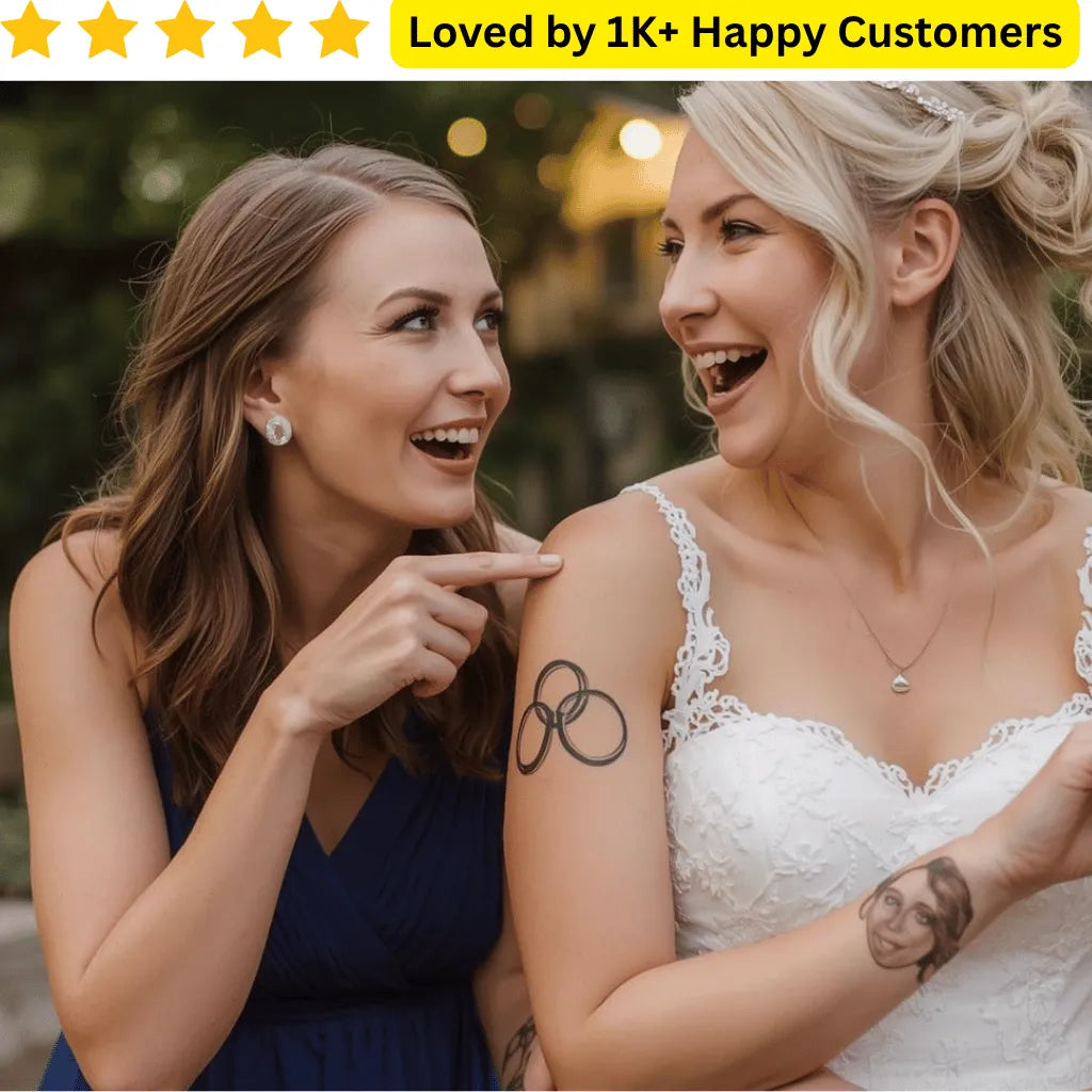 Two women, one in a blue dress and the other in a white wedding dress, with a tattoo on her arm. Explore wedding tattoo ring designs for couples, guests, and stylists—printed locally in South Africa