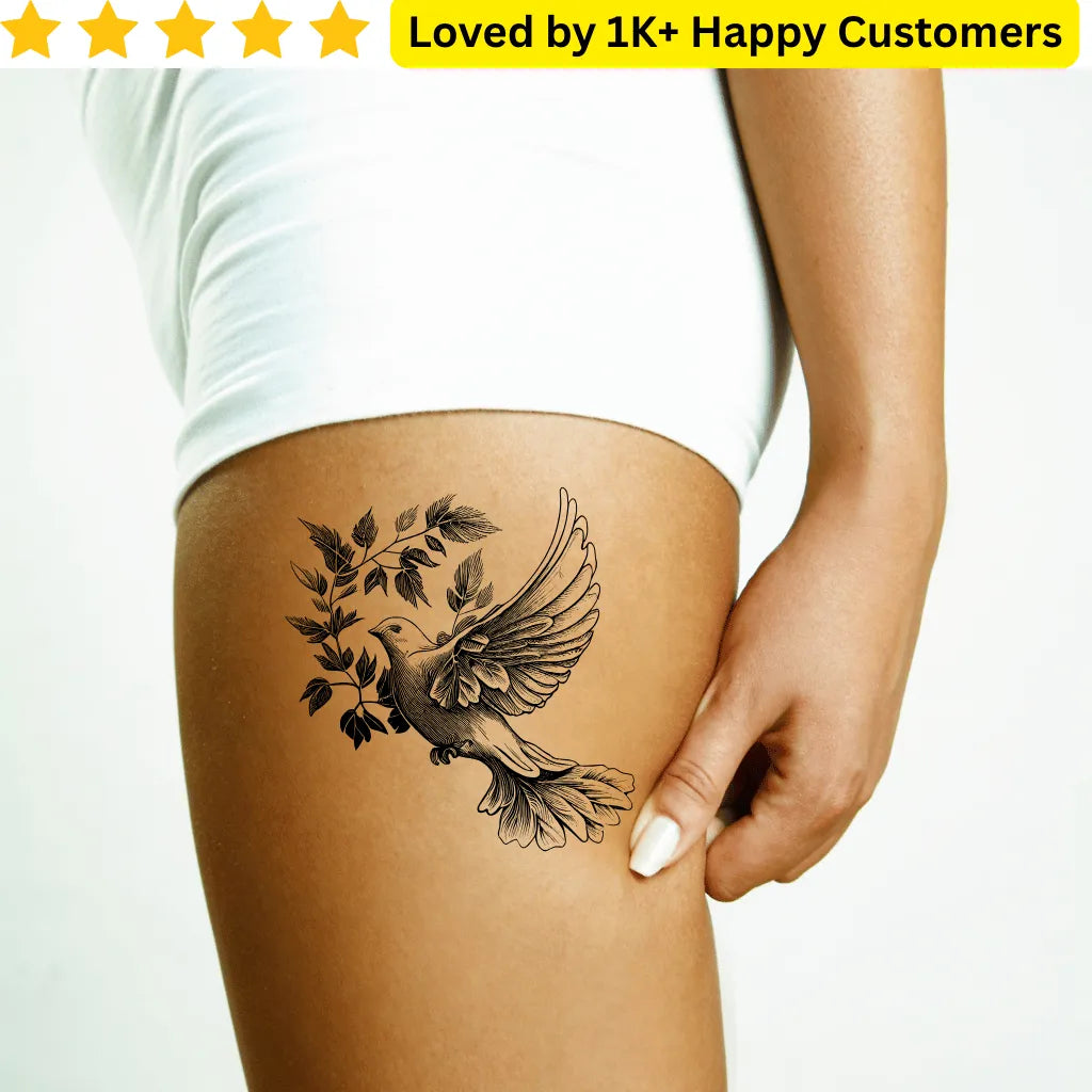 Tattoo of a bird and leaves on a person's leg with a white background and text about customer satisfaction. Elegant Tattoos for Ladies Dove on Thigh