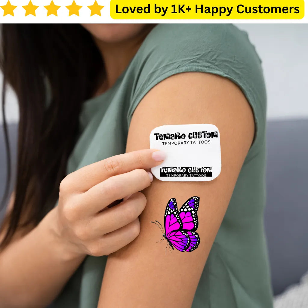Person with a pink butterfly temporary tattoo on their arm, held by a label from 'Tunero Customi'. For Women Tattoos- Discover Elegant &amp; Meaningful