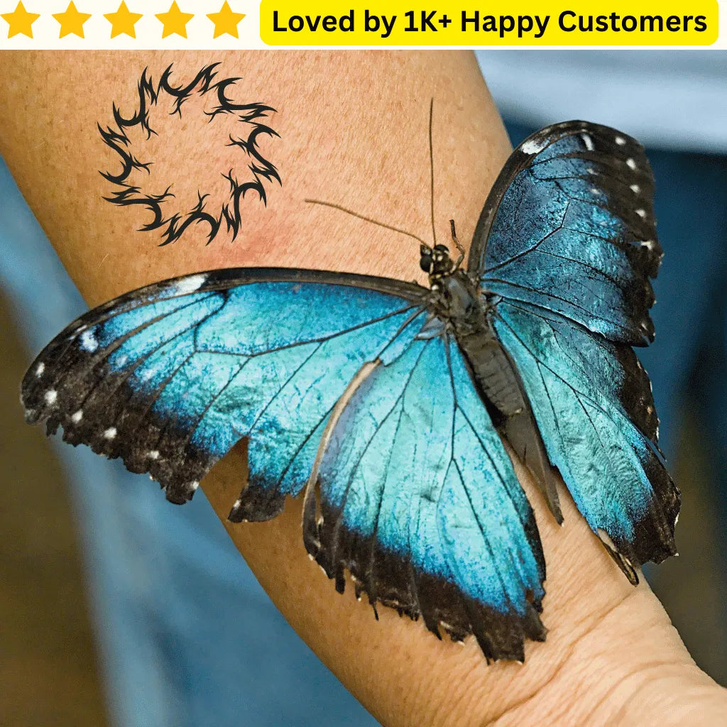 Blue butterfly on a person's arm with a tattoo, set against a blurred background. Men's Tattoos Arm for Testing Your Next Tattoo