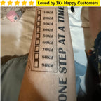 Tattoo on a person's arm with motivational text and measurement scale, with a blurred background. Custom Tattoo – Your Design, Your Statement 🎨