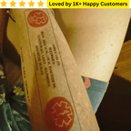 Close-up of a cardboard box with text and a logo, featuring a promotional banner at the top. Tattoo Custom Temporary – Your Design, Your Way