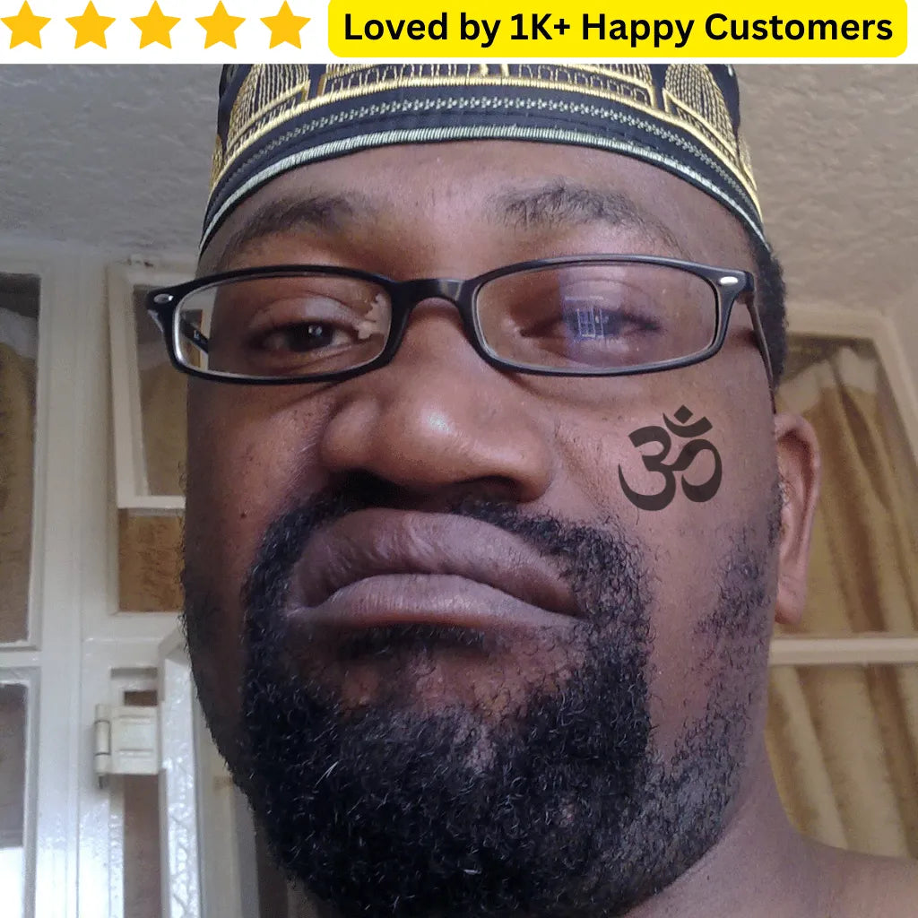 Man with glasses and a tattoo on his face, with text 'Loved by 1K+ Happy Customers' above. TeMaRo™ OM Symbol Stickon - Tattoo on Hand