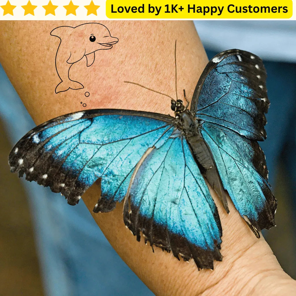 Blue butterfly on a person's arm with a tattoo of a dolphin, set against a blue background. Expressive Tattoos for Ladies Back - Love Style Without the Commitment