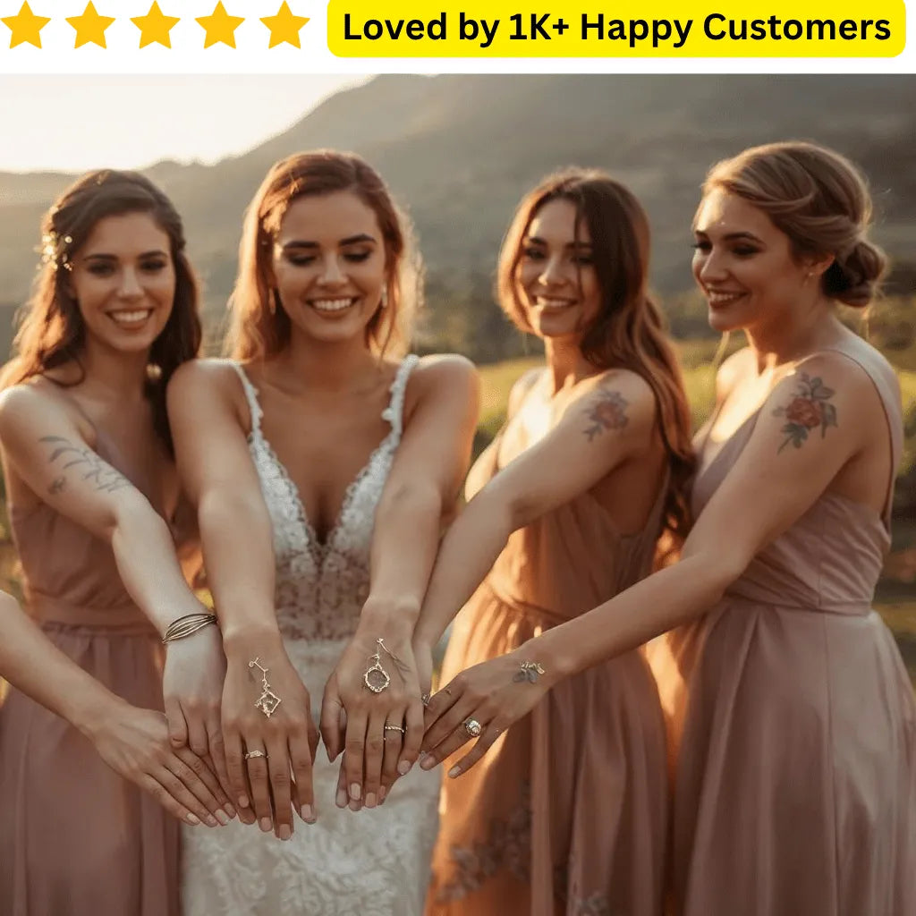 Four women in matching dresses holding hands with jewelry, set against a scenic background. Celebrate your bridal crew with custom bachelorette tattoo stickers printed in South Africa