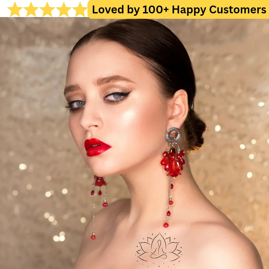 Woman wearing red earrings with a gold background and text 'Loved by 100+ Happy Customers'.Elegant Flower Tattoo Lotus for Inner Peace
