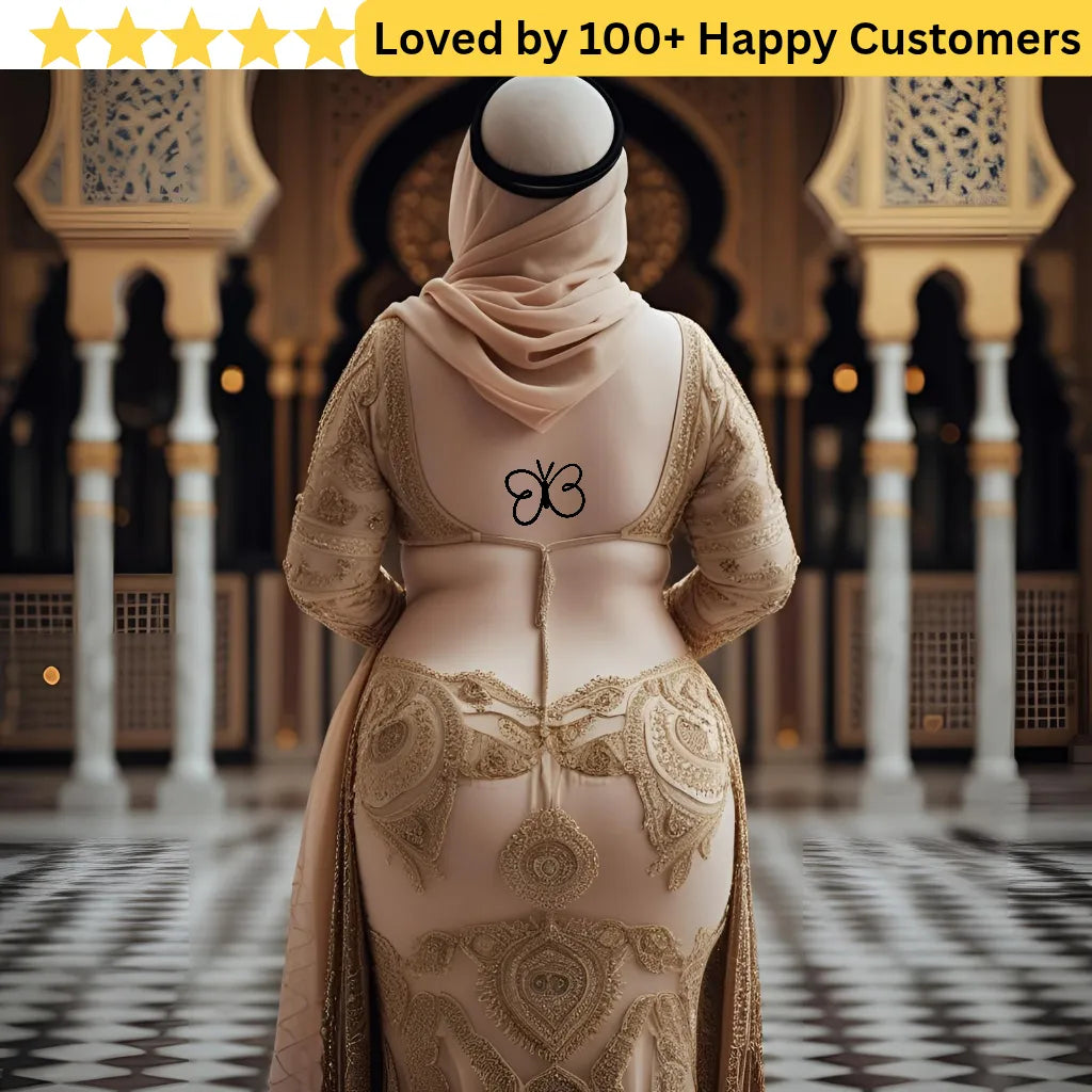 Person wearing a beige embroidered dress with a logo in an ornate indoor setting. Lower Back Tattoos Womens – Feminine & Flirty