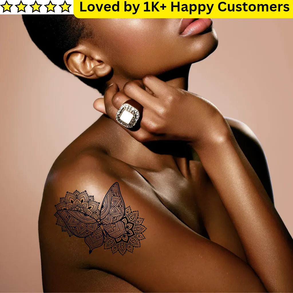 Woman with a butterfly tattoo on her shoulder against a beige background