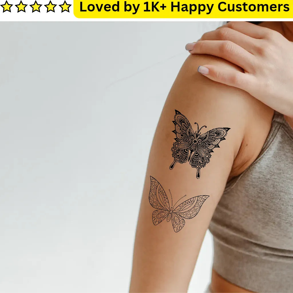 Mandala Tattoo Butterfly tattoo on a person's arm with a gray background and text 'Loved by 1K+ Happy Customers'.