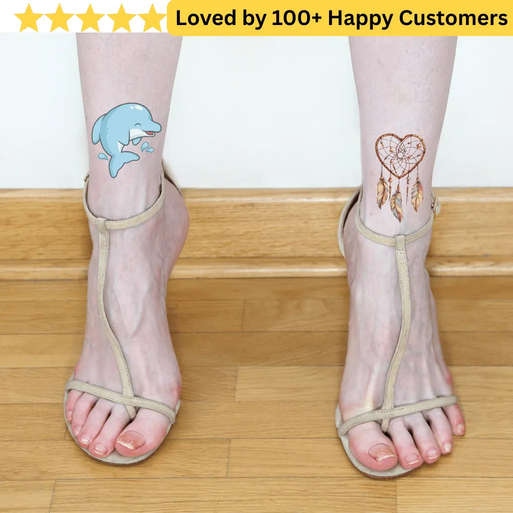 Transparent anklets with dolphin and heart tattoos on a wooden floor. tattoos for ladies feet