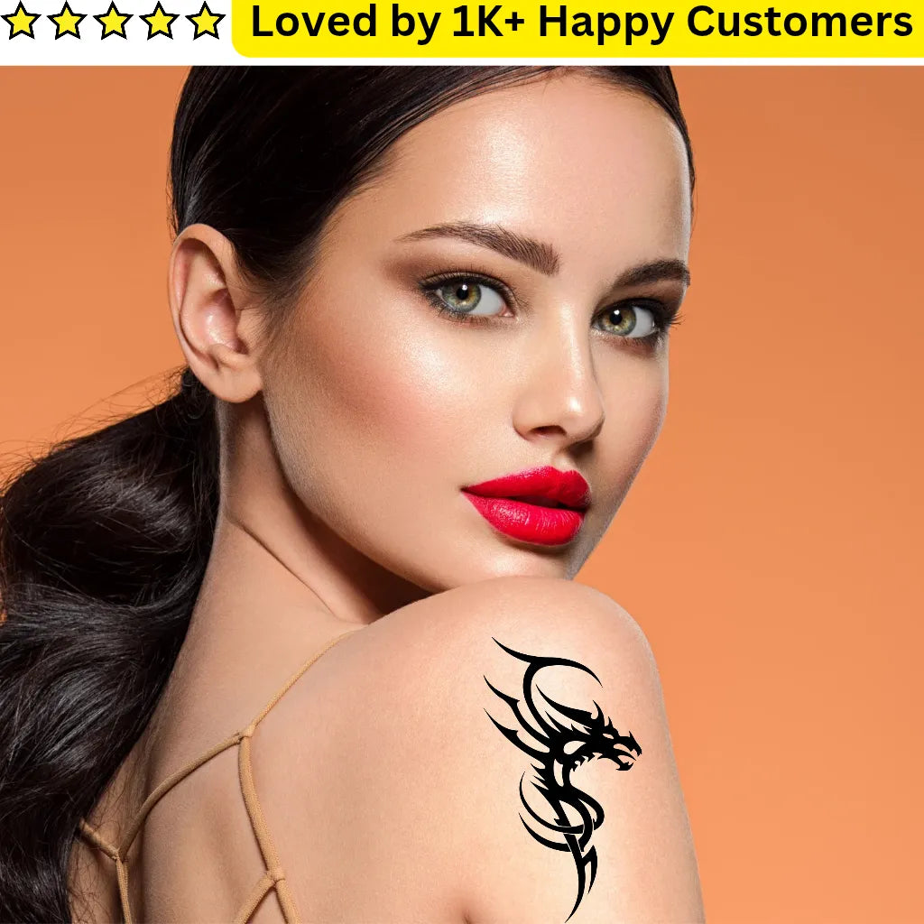 Woman with a black dragon tribal tattoo design on her shoulder against an orange background
