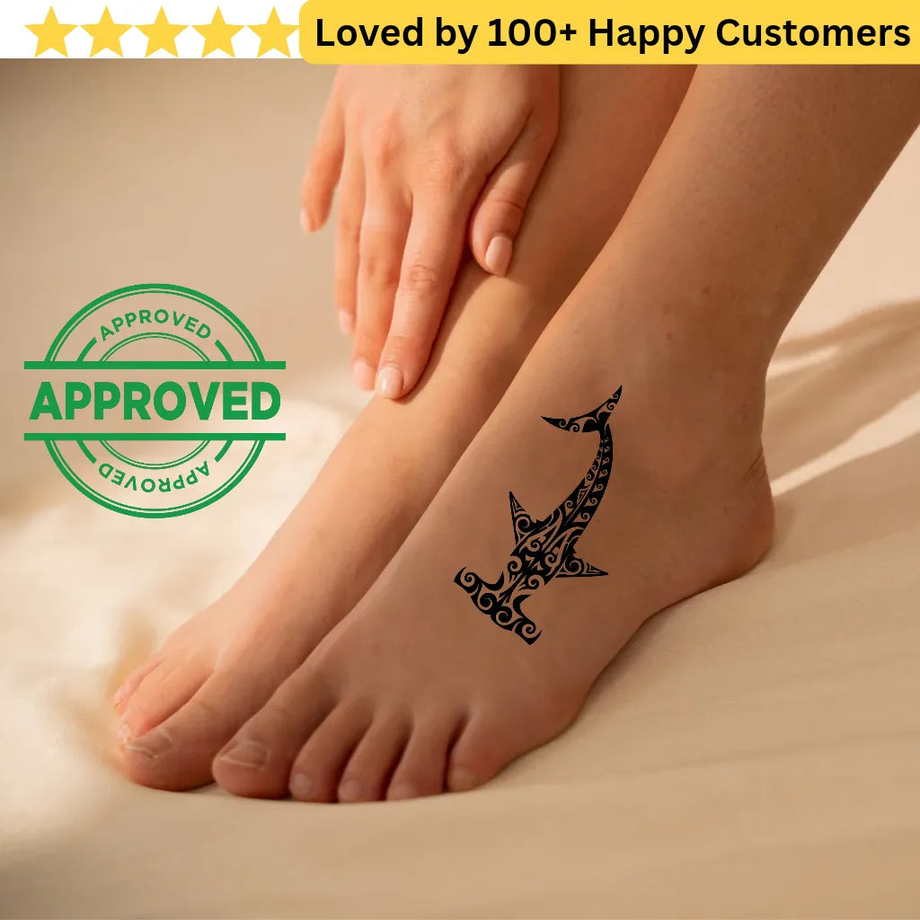 Tattoo of a shark design on a foot with 'APPROVED' stamp and text 'Loved by 100+ Happy Customers'. Tribal Tattoo Patterns – Bold & Meaningful Designs